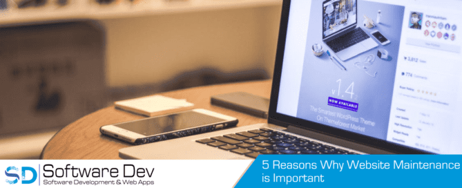 Silver laptop computer beside smartphone showing business website